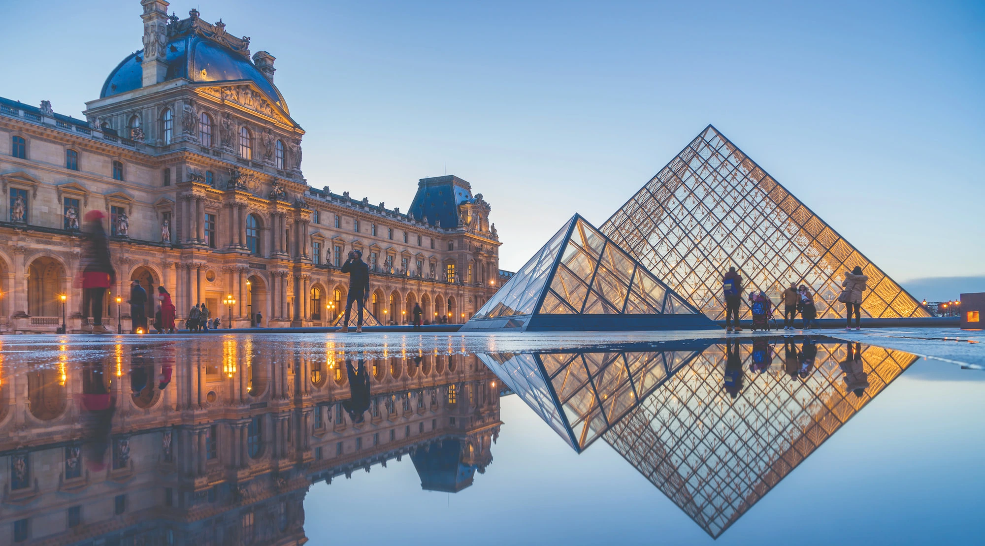 The Louvre Museum pyramid at dusk